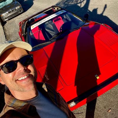 Matt Long taking a selfie with a 1980 Ferrari which he borrowed from his friend.